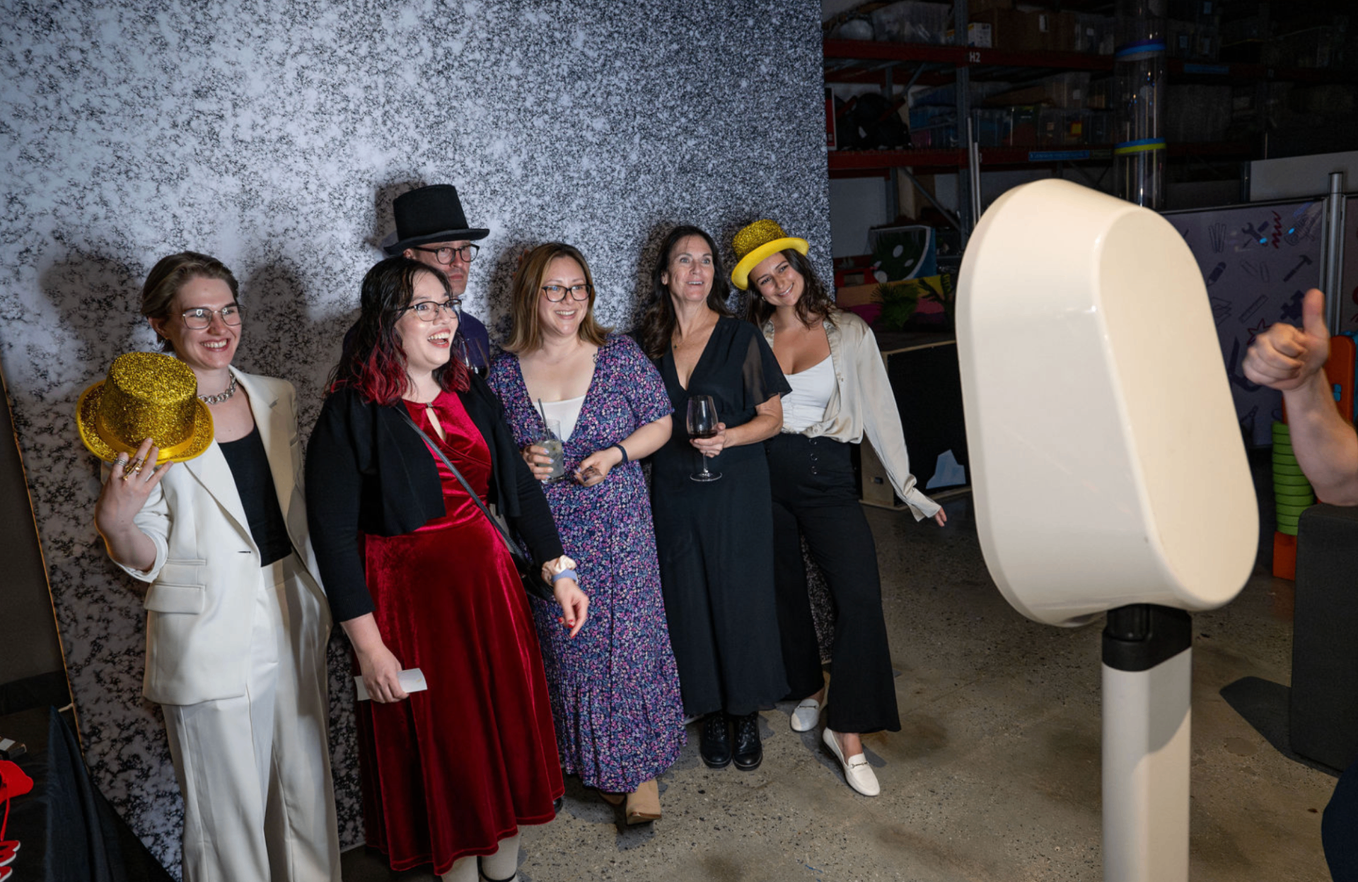 Guests in costume laughing at a photo booth