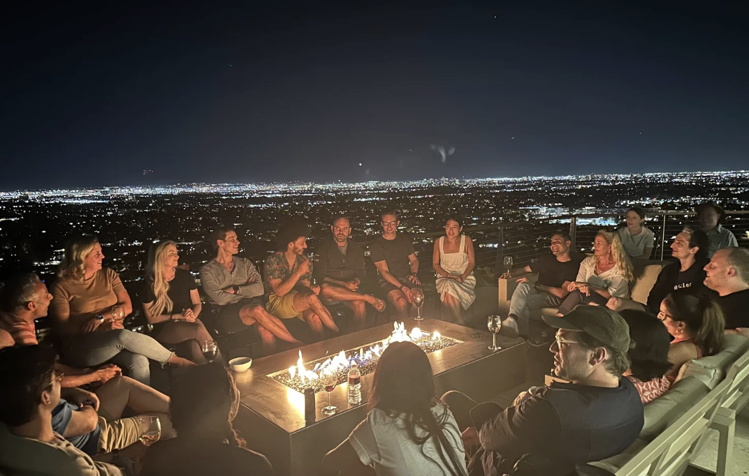 Fireside conversation above the city at night